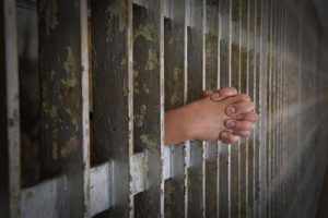 Hands-of-Prisoner-Coming-from-old-Cell-Repeat DUI Offender in Colorado gets Prison Time