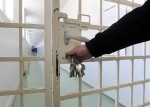 guard with keys opening Prison cell | Injustice in the Justice System