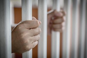 Hand on bars from the side | Sentencing Reform and Corrections Act of 2015
