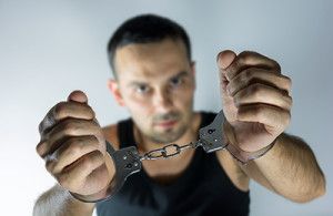 man holding up cuff hands | Colorado Misdemeanor Charges