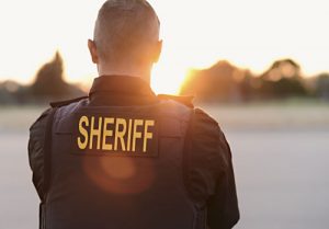 back of sheriff looking at the sunset | America’s Faulty Perception of Crime Rates